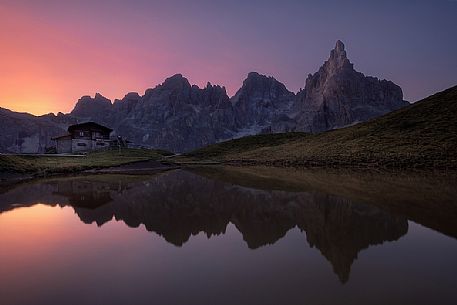 Baita Segantini hut and in the background the Pale di San Martino mountain range, dolomites, Italy