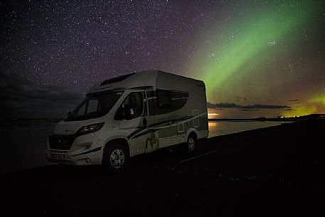 Camper and northern lights at Reynisfjara lagoon, Iceland Camper and northern lights at Reynisfjara lagoon, Iceland