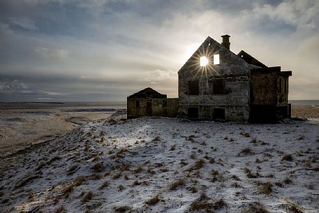 Sunrise in the house ruins at Londrangar coast, Iceland