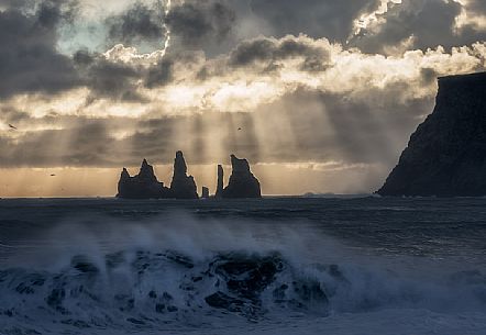 Reynisdrangar cliffs, volcanic rock formations on the coast in the storm, Vik i Myrdal, Iceland