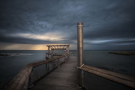 Pier on lungolaguna Trento in Lignano Sabbiadoro, Adriatic sea, Friuli Venezia Giulia, Italy
