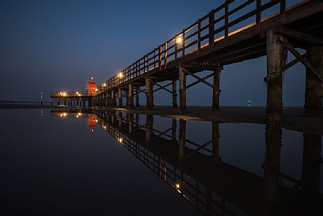 Pier and the old lighthouse by night in Lignano Sabbiadoro, Friuli Venezia Giulia, Italy Pier and the old lighthouse by night in Lignano Sabbiadoro, Friuli Venezia Giulia, Italy