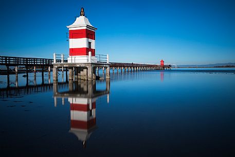 The two lighthouses and pier in Punta Faro, Lignano Sabbiadoro, Friuli Venezia Giulia, Italy