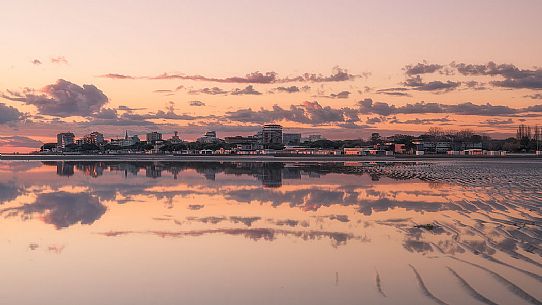 Shoreline golden reflections in Grado lagoon at sunset, Friuli Venezia Giulia, Italy Shoreline golden reflections in Grado lagoon at sunset, Friuli Venezia Giulia, Italy