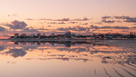 Shoreline golden reflections in Grado lagoon at sunset, Friuli Venezia Giulia, Italy