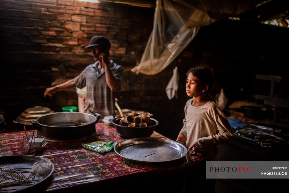 Young girl making pottery at local market Psa Kraom
