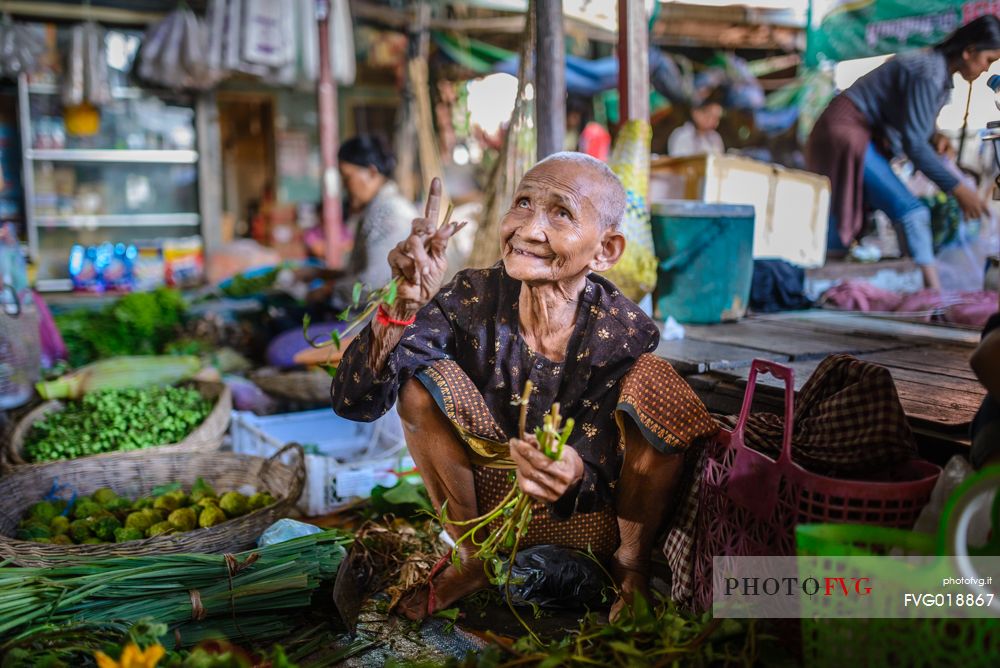 Old woman selling vegetable at local market Psa Kraom
