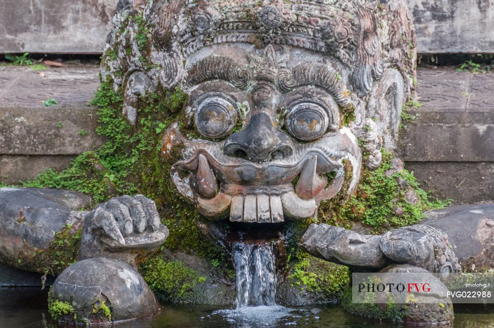 Ancient statue of the Dragon in Tirta Gangga water palace, Bali island, Indonesia