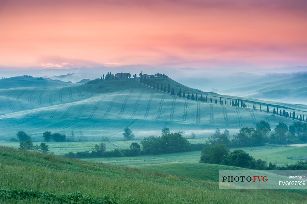 Farm in the Crete Senesi landscape at sunset, Orcia valley, Tuscany, Italy