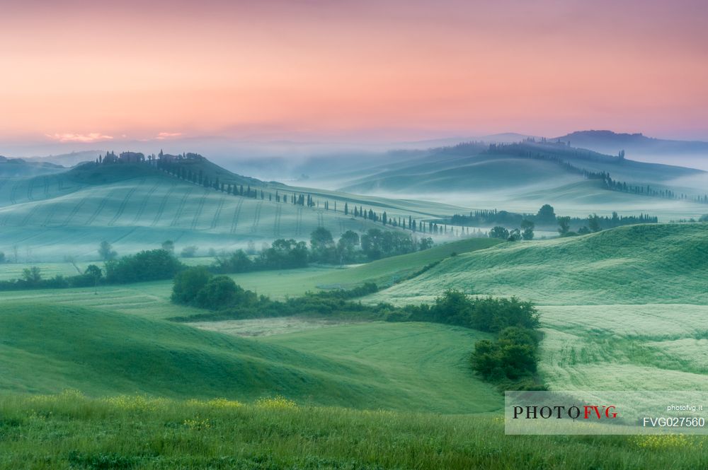 Farm in the Crete Senesi landscape at sunset, Orcia valley, Tuscany, Italy