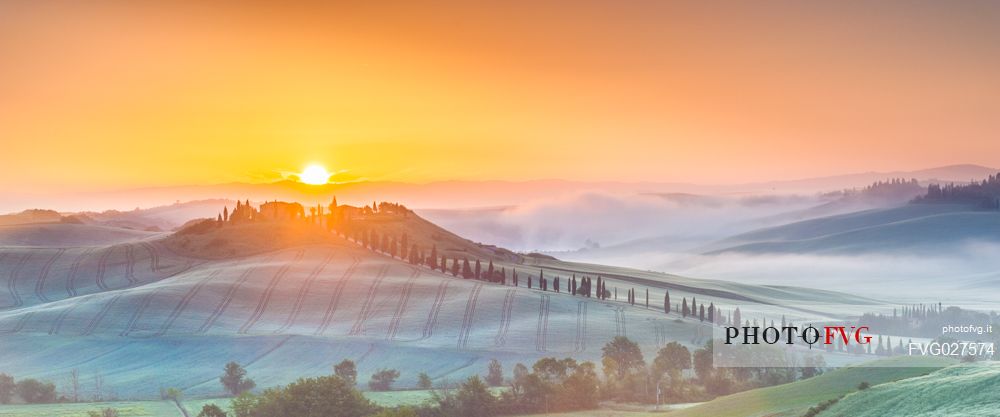 Farm in the Crete Senesi landscape at sunset, Orcia valley, Tuscany, Italy