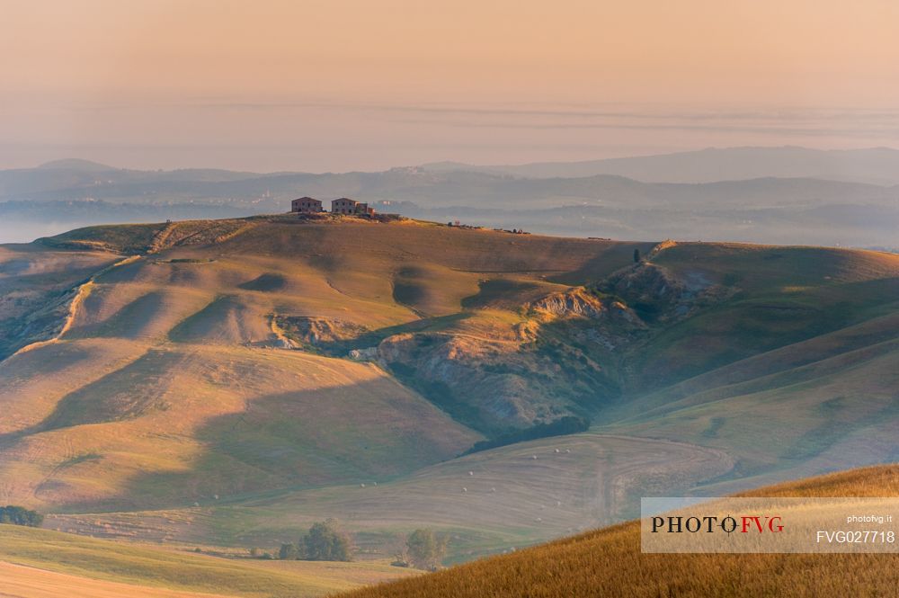 Farm in the Crete Senesi landscape at sunset, Orcia valley, Tuscany, Italy