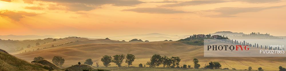 Farm in the Crete Senesi landscape at sunrise, Orcia valley, Tuscany, Italy