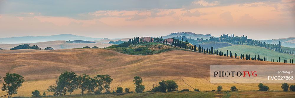 Farm in the Crete Senesi landscape at sunrise, Orcia valley, Tuscany, Italy