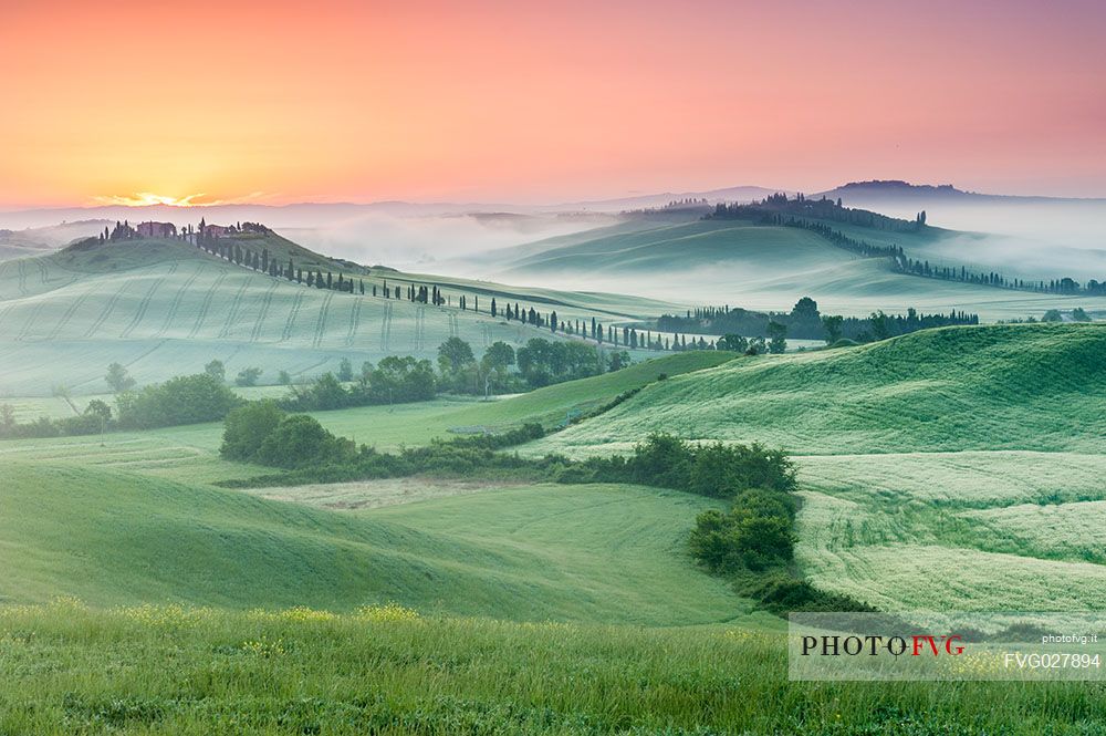 Farm in the Crete Senesi landscape at sunset, Orcia valley, Tuscany, Italy