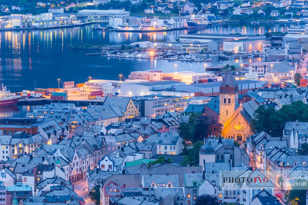 View from Aksla mountain towards Alesund old town and harbour illuminated at dusk, Norway