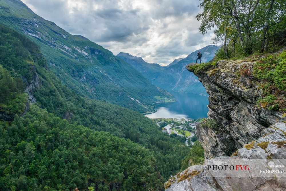 Photographer on the Flydalsjuvet rock, over the Geiranger fjord, Norway