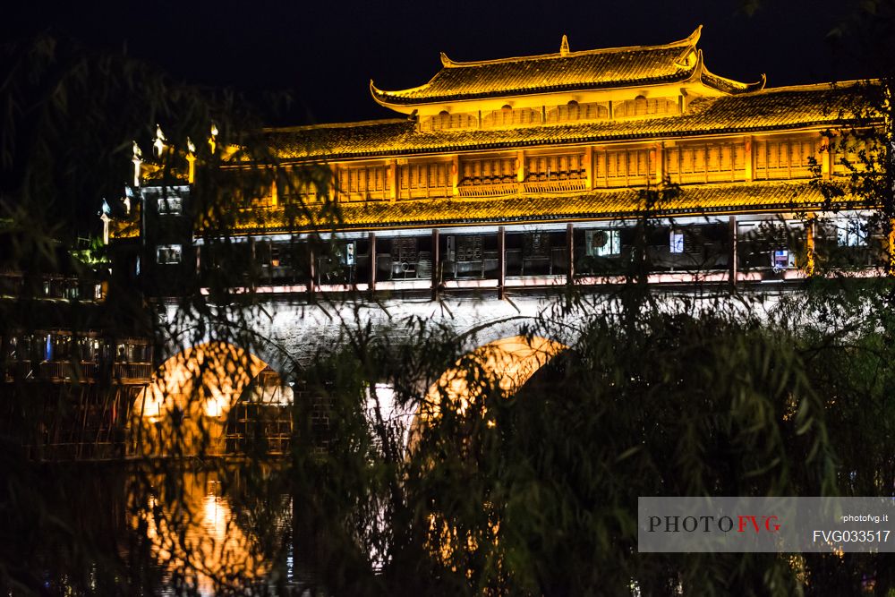 Phoenix Hong Bridge or Rainbow bridge at night in Fenghuang ancient town, Hunan, China