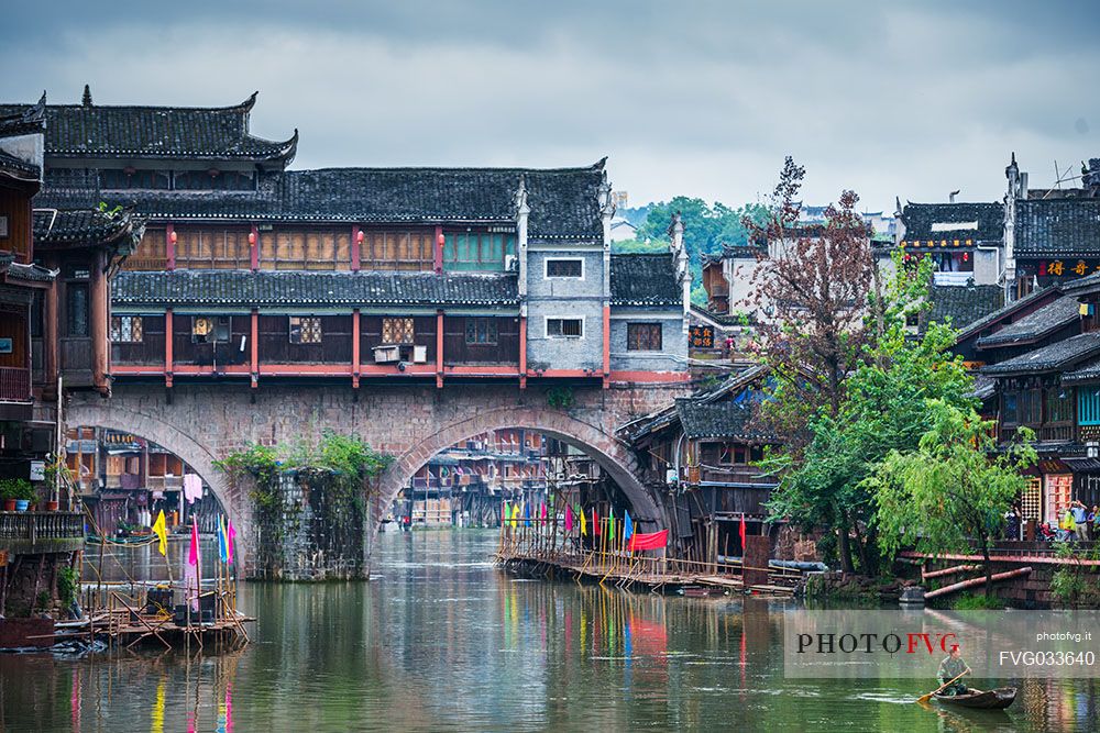 Sailing along Tuojiang river, Phoenix Hong Bridge or Rainbow bridge in Fenghuang ancient town, Hunan, China