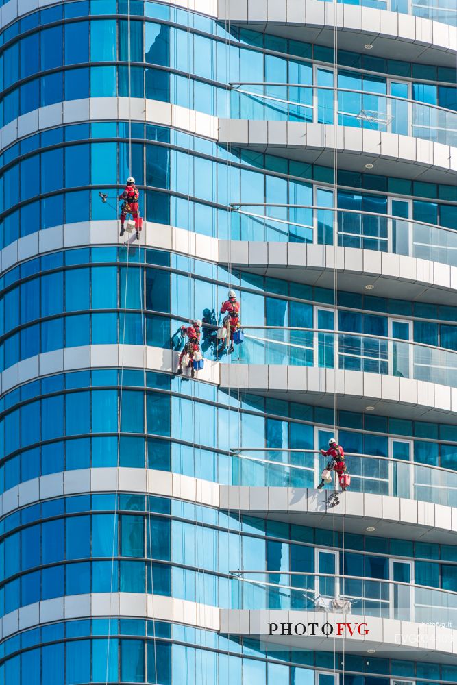 Window cleaners on skyscrapers of Abu Dhabi city, Emirate of Abu Dhabi, United Arab Emirates, UAE