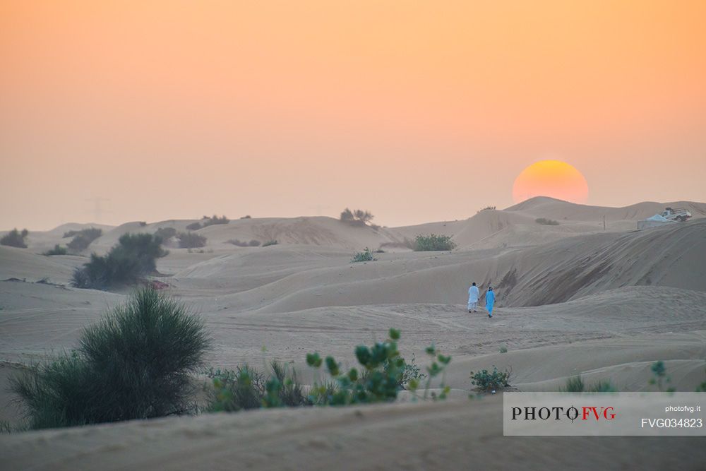 Arab men in the desert at sunset, Dubai, United Arab Emirates, Asia