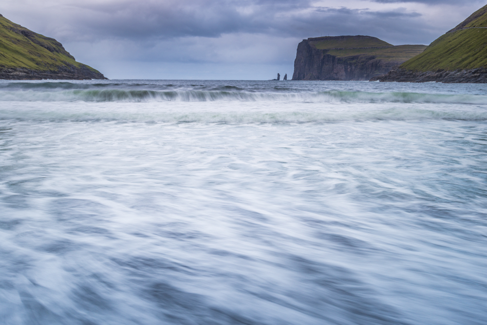 Wild sea and in the background the sea stacks of Risin and Kellingin, just off the northern coast of the island of Eysturoy from Tjornuvik village, Streymoy island, Faeroe islands, Denmark, Europe