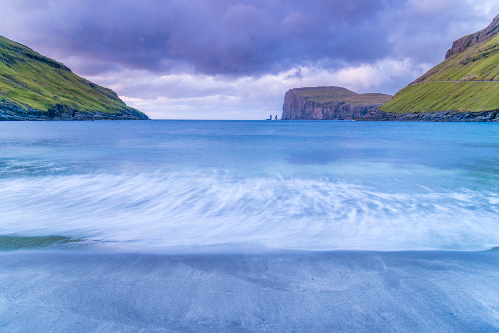 Wild sea and in the background the sea stacks of Risin and Kellingin, just off the northern coast of the island of Eysturoy from Tjornuvik village, Streymoy island, Faeroe islands, Denmark, Europe