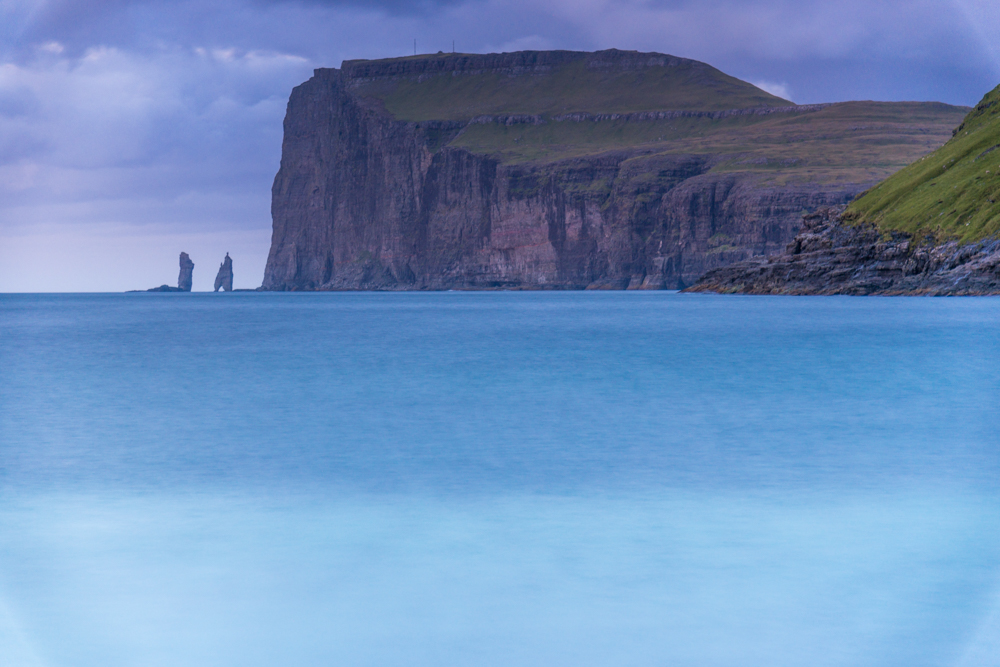 Wild sea and in the background the sea stacks of Risin and Kellingin, just off the northern coast of the island of Eysturoy from Tjornuvik village, Streymoy island, Faeroe islands, Denmark, Europe