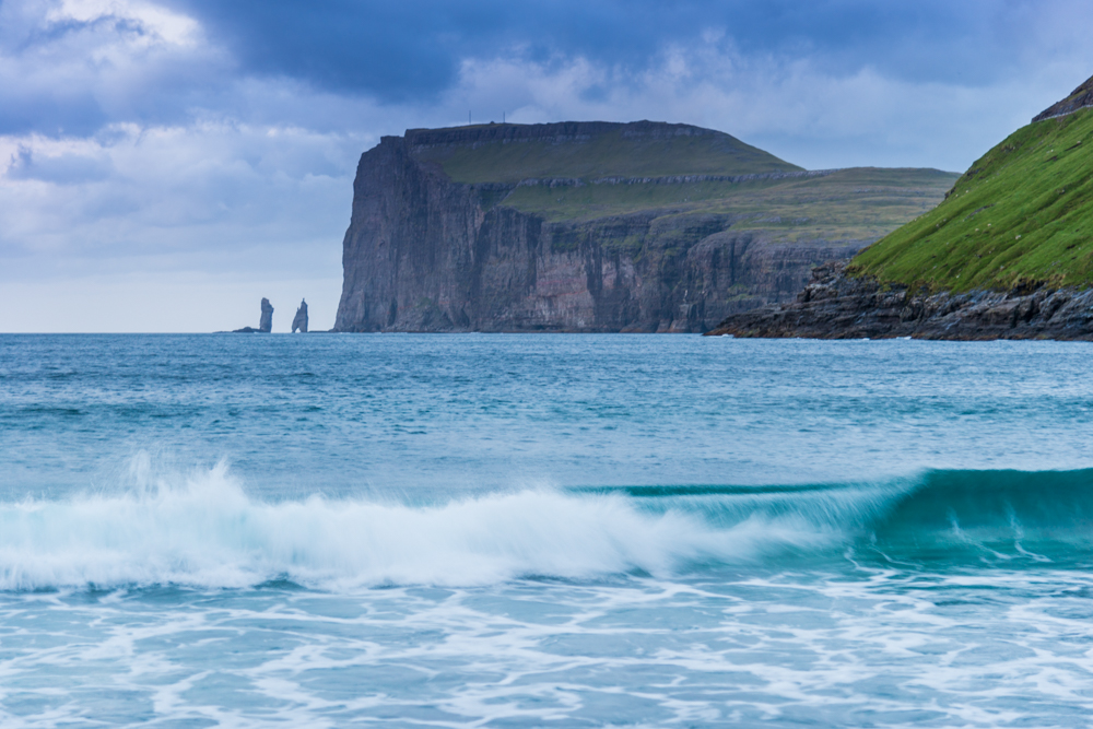 Wild sea and in the background the sea stacks of Risin and Kellingin, just off the northern coast of the island of Eysturoy from Tjornuvik village, Streymoy island, Faeroe islands, Denmark, Europe