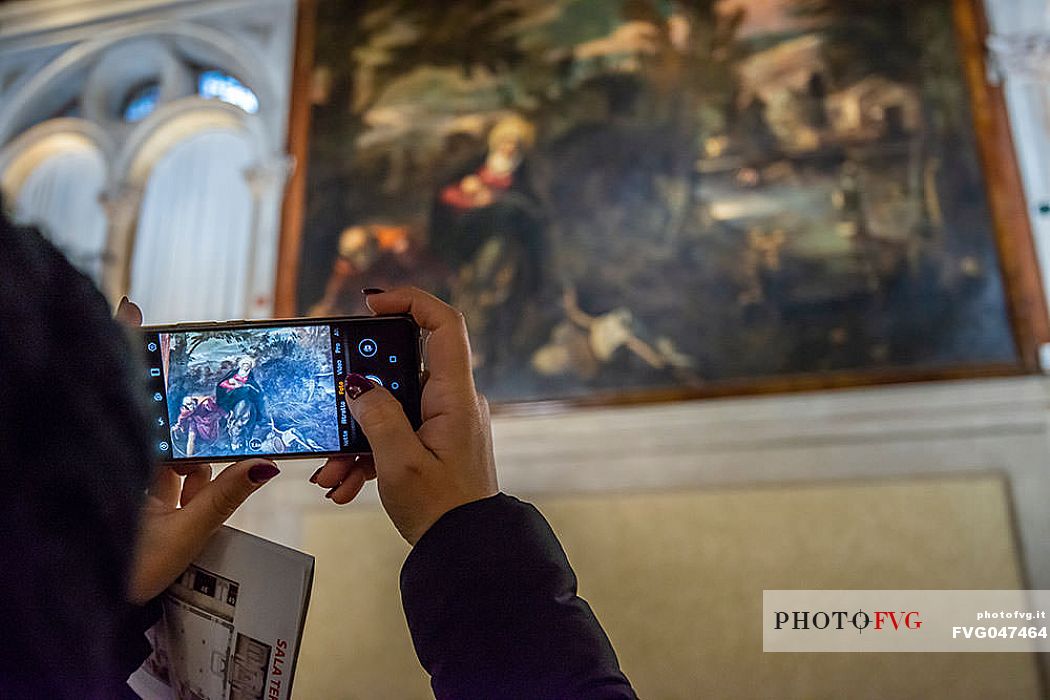 Tourist taking a picture inside the Scuola Grande di San Rocco, Venice, Veneto, Italy, Europe