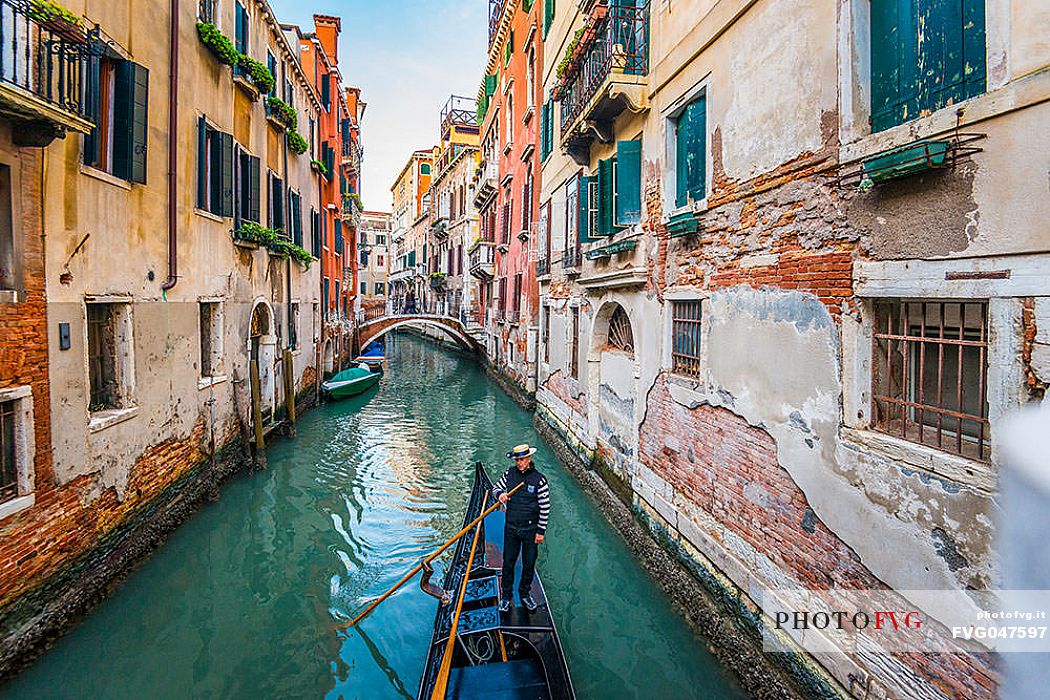 Gondolier in the gondola in Venice's canal, Venice, Veneto, Italy, Europe