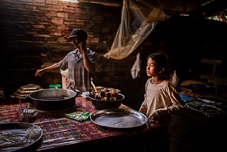 Young girl making pottery at local market Psa Kraom
