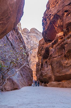 Tourists hiking in the canyon near the old village of Petra, Jordan