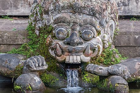 Ancient statue of the Dragon in Tirta Gangga water palace, Bali island, Indonesia