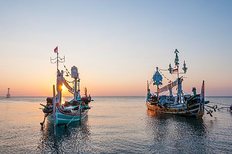 Traditional boats in a beautiful sunset in Lovina Beach, Bali island, Indonesia Traditional boats in a beautiful sunset in Lovina Beach, Bali island, Indonesia