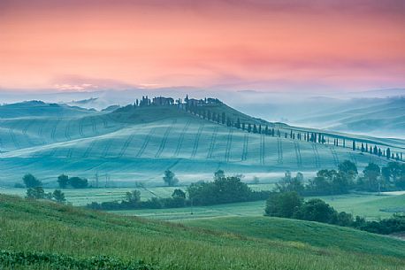 Farm in the Crete Senesi landscape at sunset, Orcia valley, Tuscany, Italy