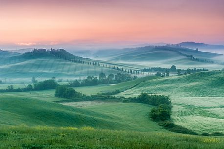 Farm in the Crete Senesi landscape at sunset, Orcia valley, Tuscany, Italy