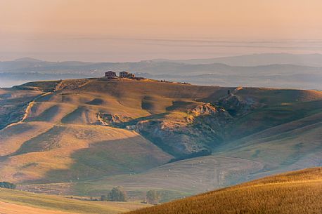 Farm in the Crete Senesi landscape at sunset, Orcia valley, Tuscany, Italy