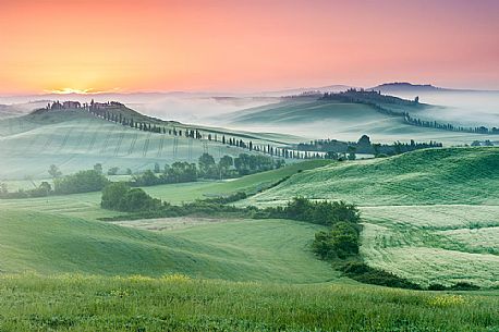 Farm in the Crete Senesi landscape at sunset, Orcia valley, Tuscany, Italy