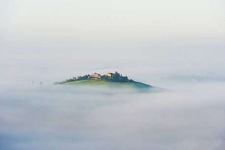 Clouds surround the landscape of Crete Senesi, Orcia valley, Tuscany, Italy