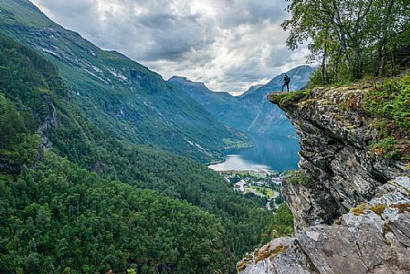 Photographer on the Flydalsjuvet rock, over the Geiranger fjord, Norway Photographer on the Flydalsjuvet rock, over the Geiranger fjord, Norway