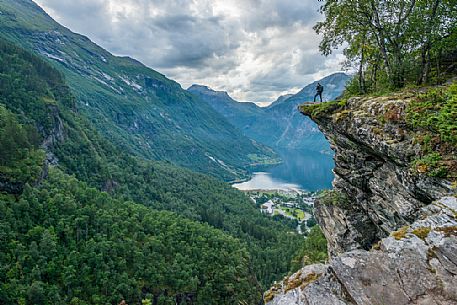 Photographer on the Flydalsjuvet rock, over the Geiranger fjord, Norway