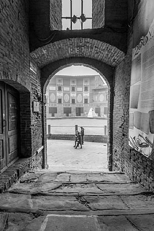 Tourist in the Piazza del Seminario square, in the backgrournd the episcopal seminary of San Miniato village, Tuscany, Italy