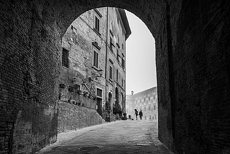 Gate in the Piazza del Seminario square, in the background the episcopal seminary of San Miniato village, Tuscany, Italy Gate in the Piazza del Seminario square, in the background the episcopal seminary of San Miniato village, Tuscany, Italy