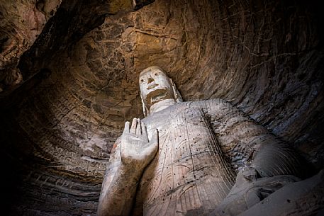 The beautiful ancient remains of Buddha Statue in Yungang Grottoes, Datong, Shanxi Province, China The beautiful ancient remains of Buddha Statue in Yungang Grottoes, Datong, Shanxi Province, China