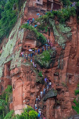 Tourists climb the cliff to admiring the Giant Buddha, the largest buddha of the world carved on Emei Shan, sacred mount, Leshan, Sichuan, China Tourists climb the cliff to admiring the Giant Buddha, the largest buddha of the world carved on Emei Shan, sacred mount, Leshan, Sichuan, China