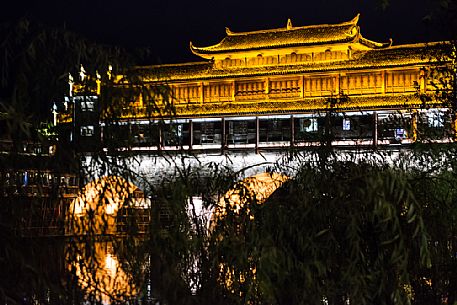 Phoenix Hong Bridge or Rainbow bridge at night in Fenghuang ancient town, Hunan, China