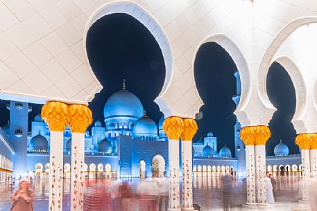 People in the courtyard of of Sheikh Zayed Grand Mosque in the City of Abu Dhabi at twilight, Emirate of Abu Dhabi, United Arab Emirates, UAE People in the courtyard of of Sheikh Zayed Grand Mosque in the City of Abu Dhabi at twilight, Emirate of Abu Dhabi, United Arab Emirates, UAE
