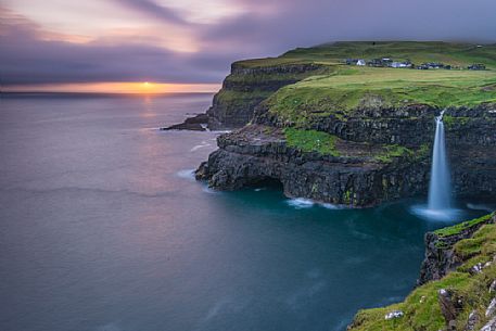 Coast with Mlafossur waterfall and the village of Gsedal or Gsadalur, Vgar Island (Vg), Faeroe Islands, Denmark, Europe