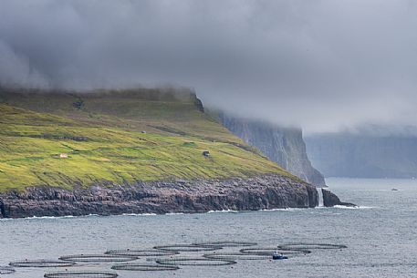 View of Trllkonufingur with fish farming, Vagar island, Faroe Islands, Denmark, Europe